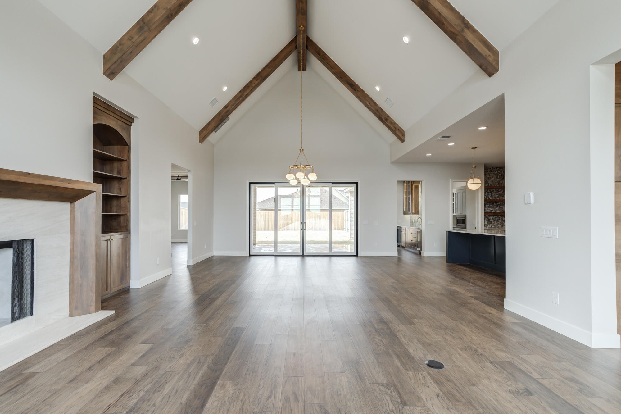 14102 Salisbury Avenue Lubbock, TX 79424 - Photo 14 of 76 a view of an empty room with wooden floor and a window