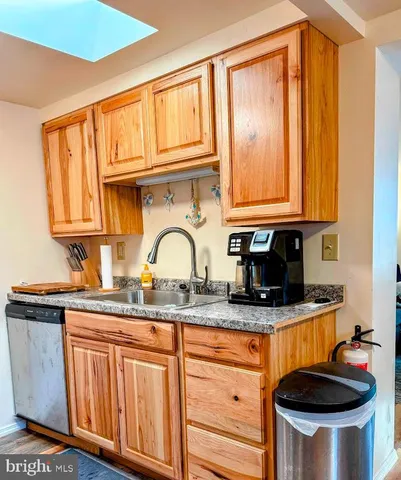 a kitchen with stainless steel appliances granite countertop a sink a stove and cabinets