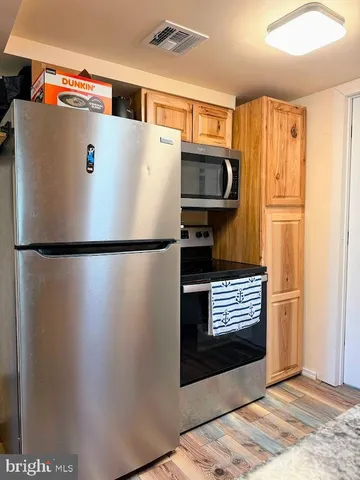 a view of kitchen cabinets and refrigerator