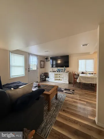 a living room with fireplace furniture and a flat screen tv