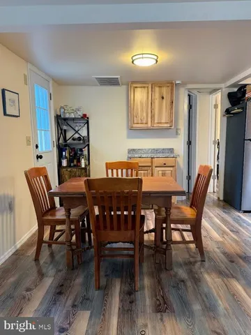 a dining room with furniture and wooden floor