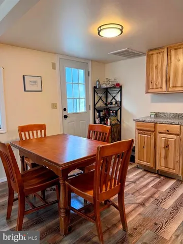 a view of a dining room with furniture and window