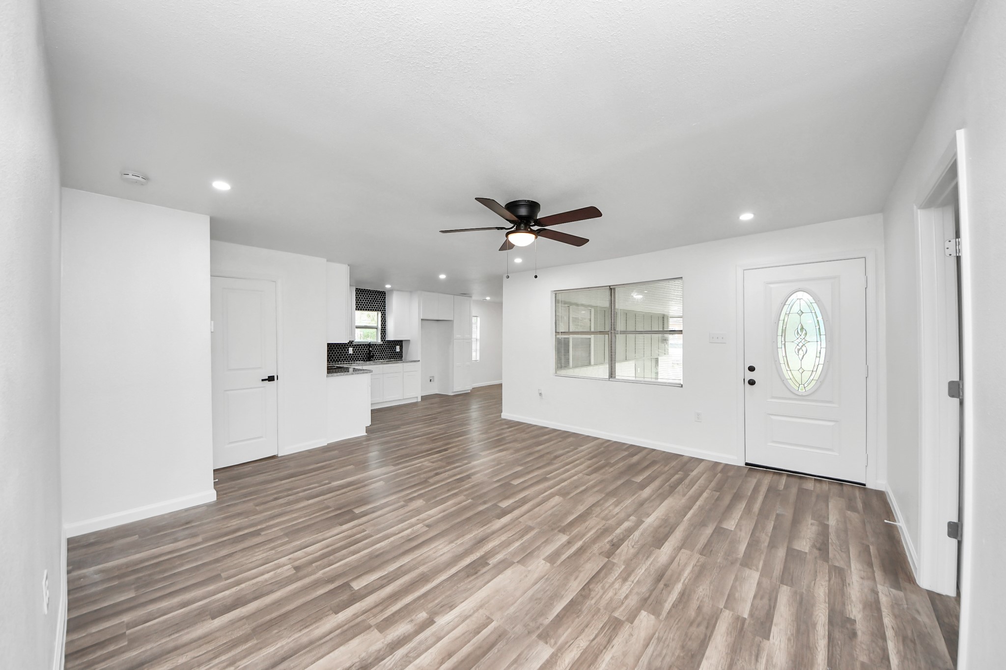 207 East Defee Avenue Baytown, TX 77520 - Photo 10 of 36 a view of an empty room with wooden floor and a window