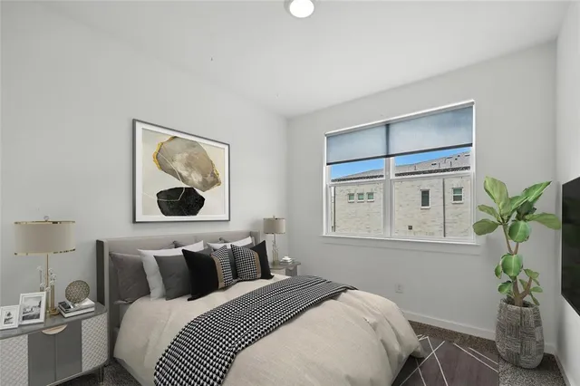 a bedroom with bed painting on the wall and a potted plant