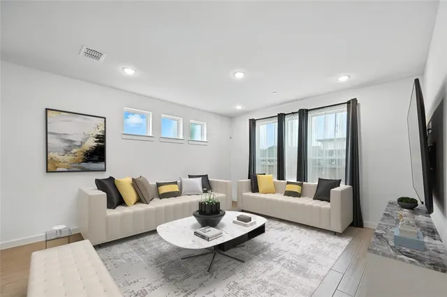 a living room with furniture and a large window