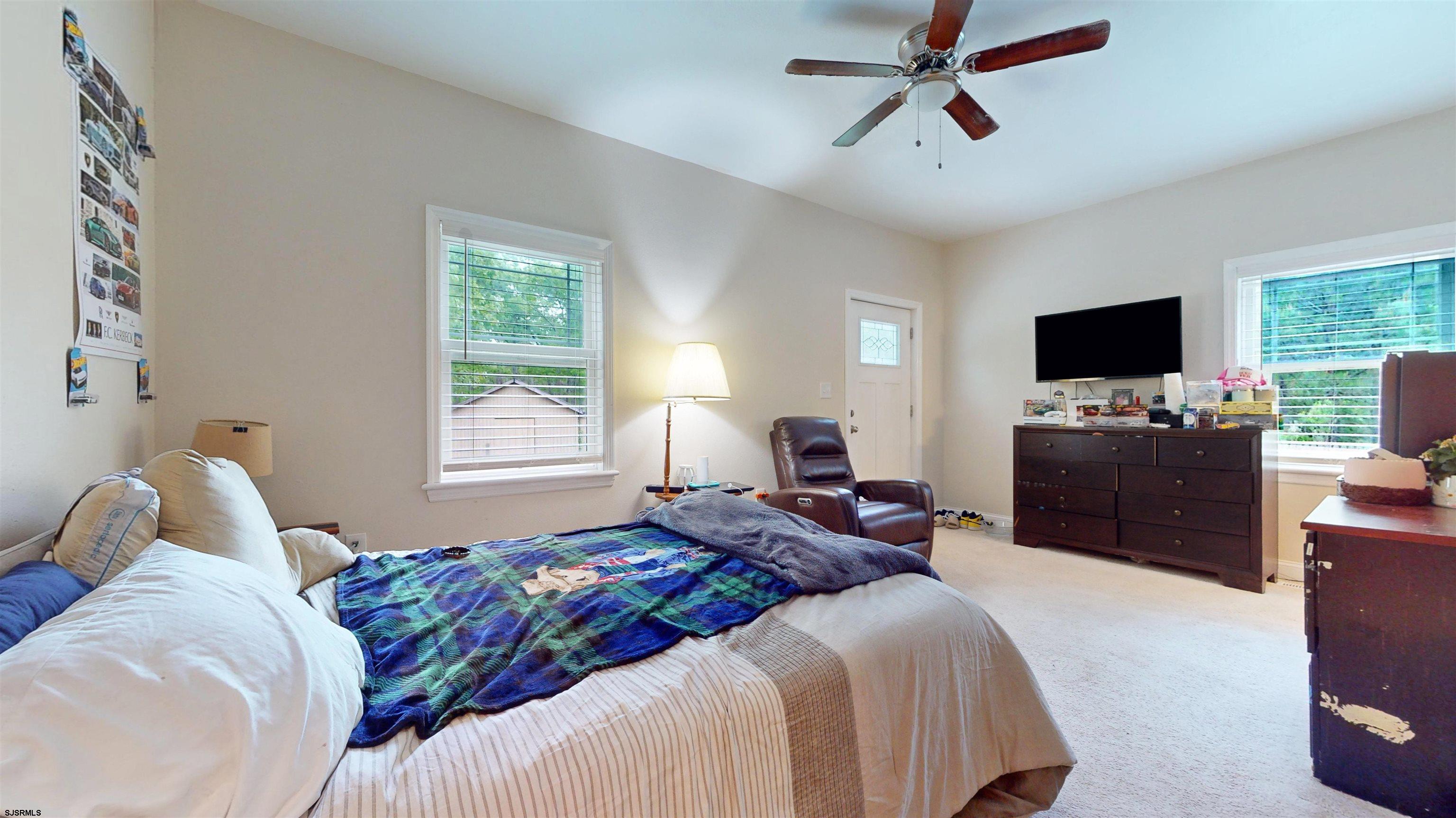 181 3rd Estell Manor, NJ 08319 - Photo 12 of 34 a bedroom with a bed and a flat screen tv