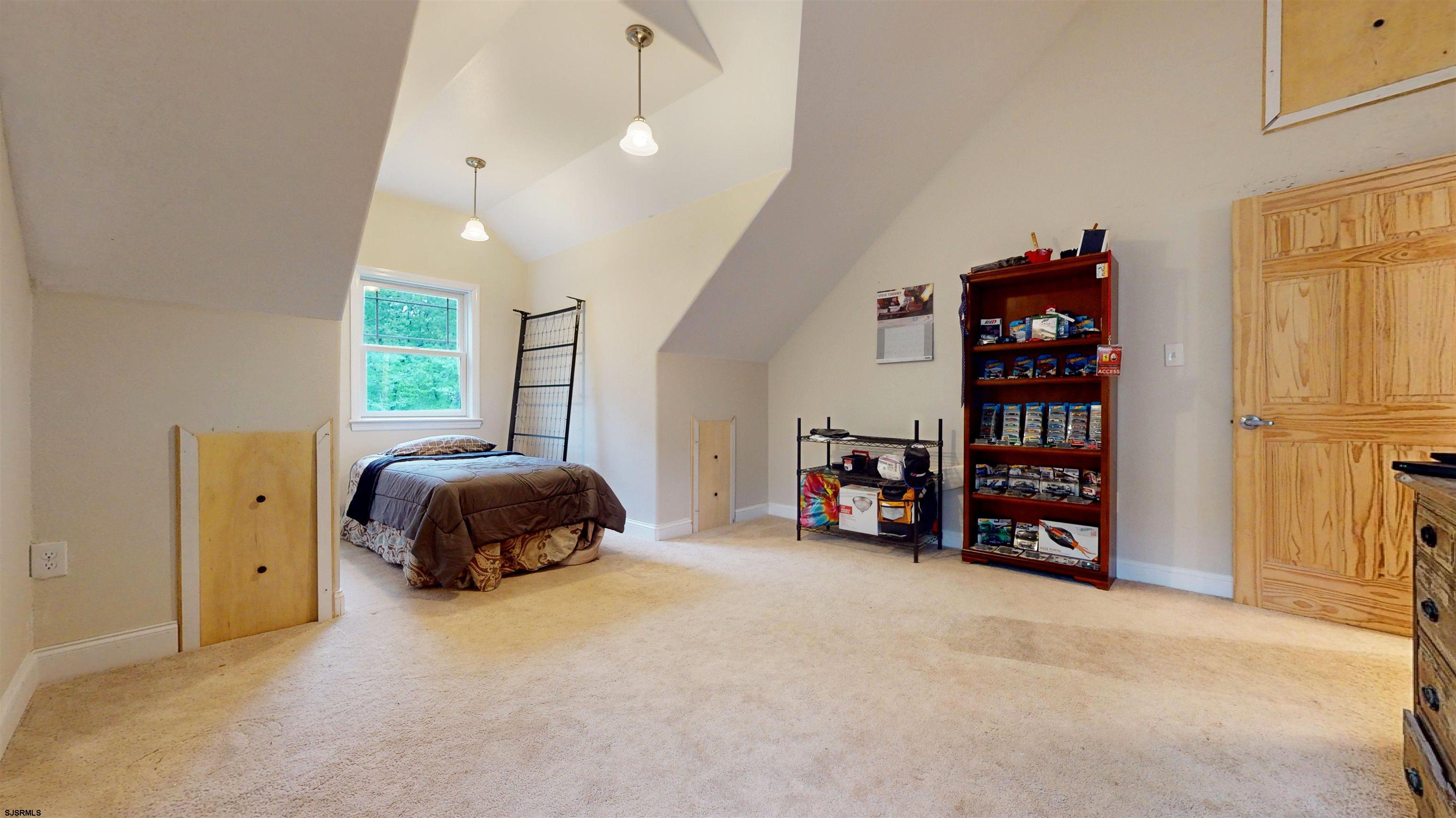 181 3rd Estell Manor, NJ 08319 - Photo 19 of 34 a bedroom with a bed a window and bookshelf
