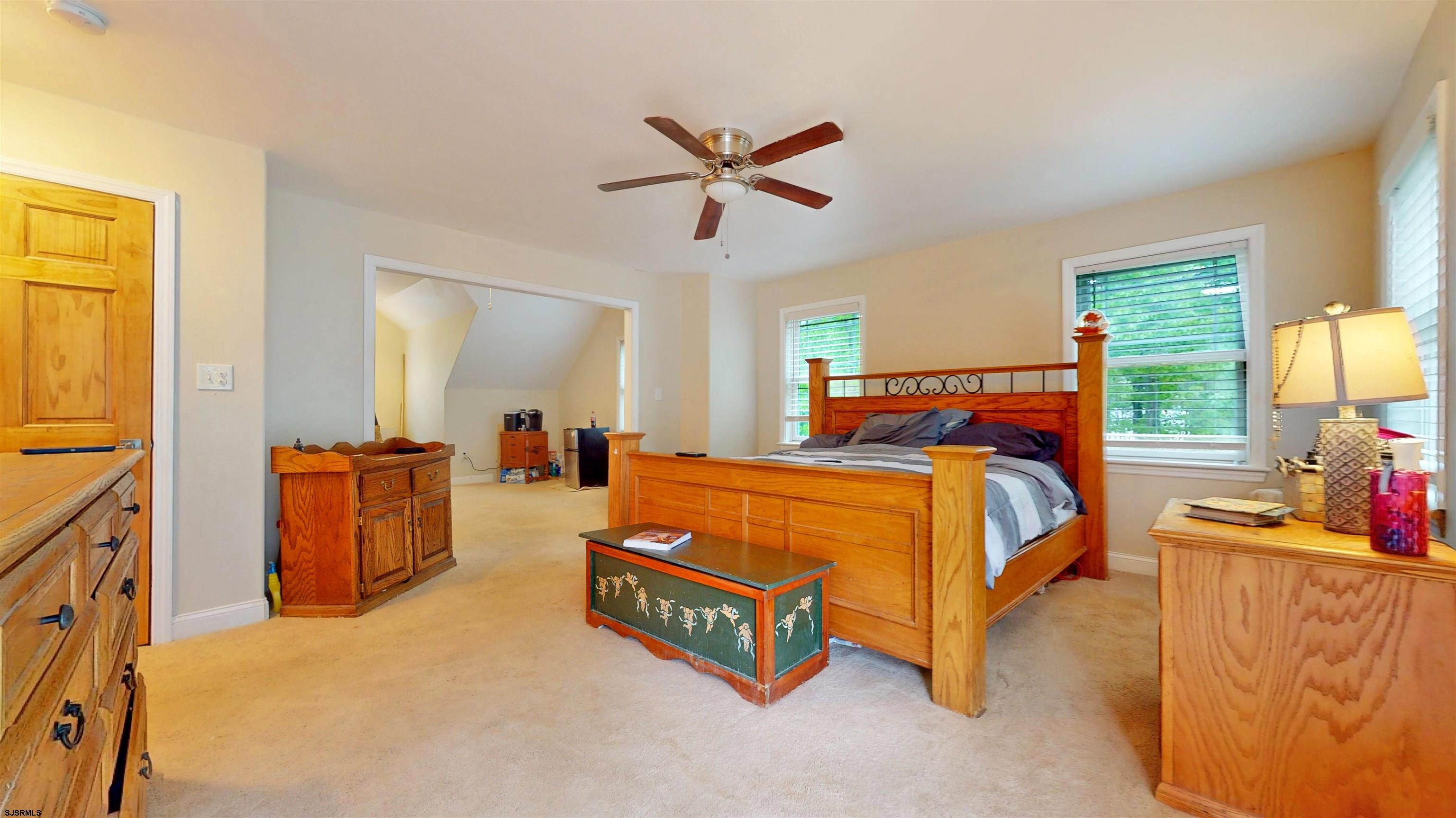 181 3rd Estell Manor, NJ 08319 - Photo 21 of 34 a bed room with a bed and a chandelier