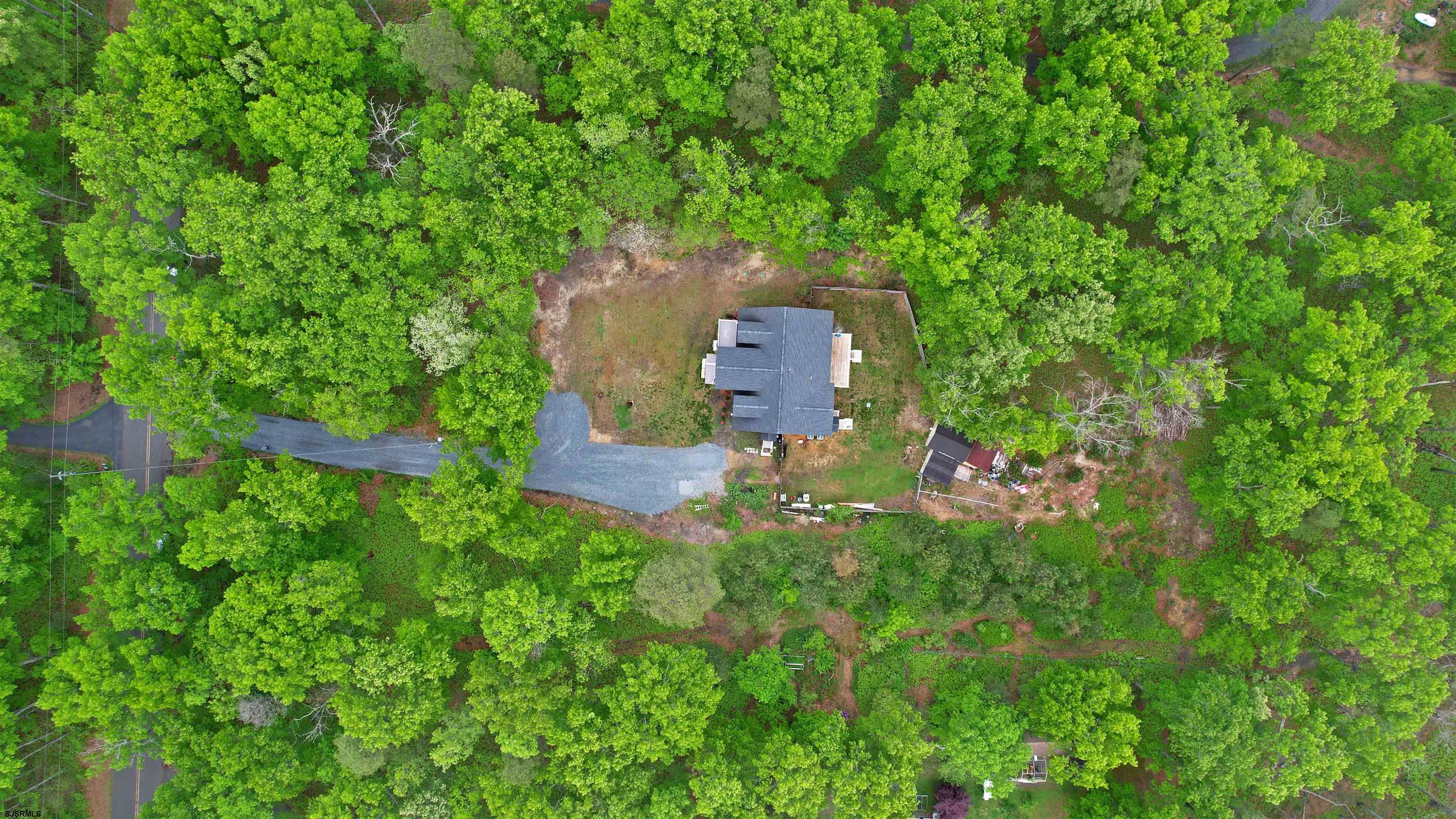 181 3rd Estell Manor, NJ 08319 - Photo 33 of 34 an aerial view of a house with a yard and large trees