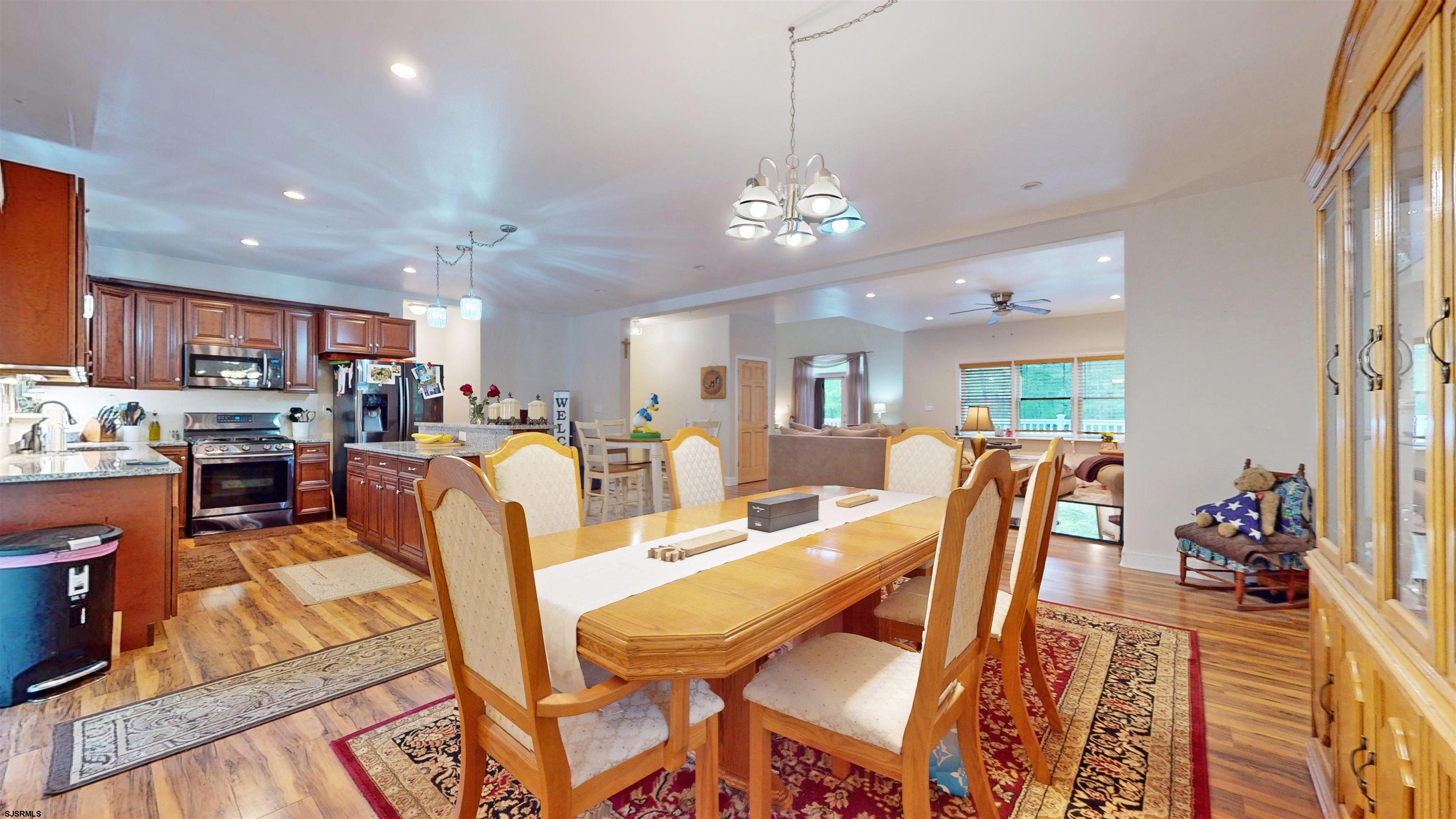 181 3rd Estell Manor, NJ 08319 - Photo 4 of 34 a view of a dining area with furniture a chandelier and wooden floor