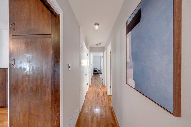 1024 West Riverside Way San Jose, CA 95129 - Photo 15 of 31 a view of a hallway with wooden floor and a bathroom