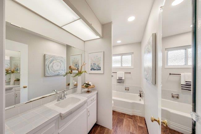 1024 West Riverside Way San Jose, CA 95129 - Photo 18 of 31 a bathroom with a tub sink and mirror