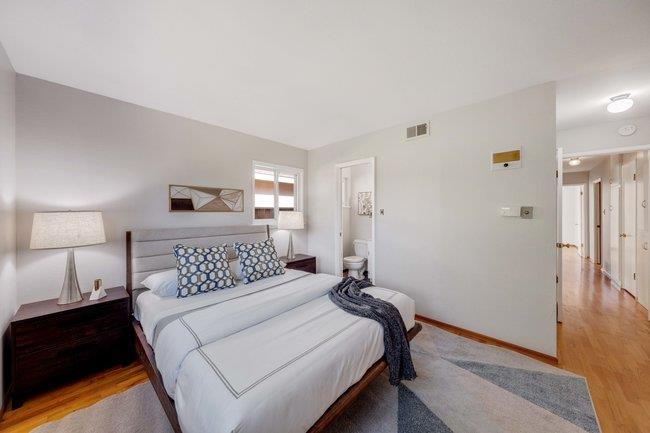 1024 West Riverside Way San Jose, CA 95129 - Photo 21 of 31 a bedroom with a bed and wooden floor