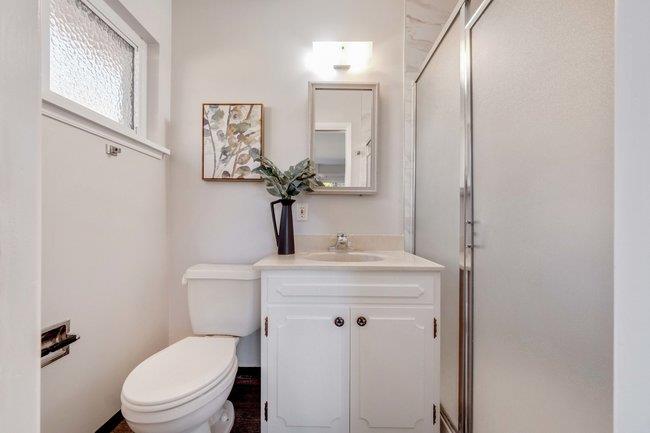 1024 West Riverside Way San Jose, CA 95129 - Photo 22 of 31 a bathroom with a granite countertop toilet sink and mirror