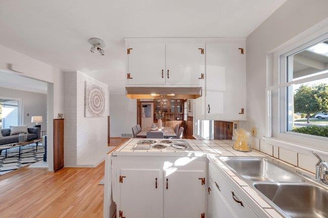 1024 West Riverside Way San Jose, CA 95129 - Photo 7 of 31 a kitchen with stainless steel appliances sink stove and cabinets