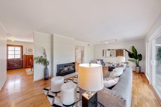 1024 West Riverside Way San Jose, CA 95129 - Photo 10 of 31 a living room with furniture a wooden floor and a fireplace