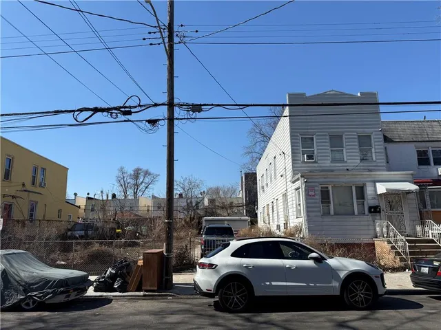 a view of a car parked in front of a house