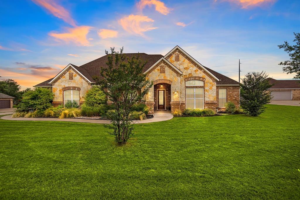a front view of a house with garden
