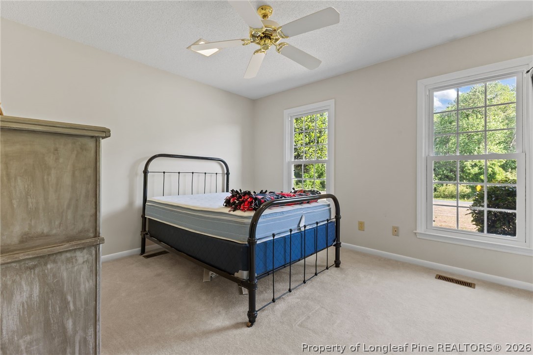 203 White Oak Church Road Clinton, NC 28328 - Photo 16 of 49 a room with a bed and window