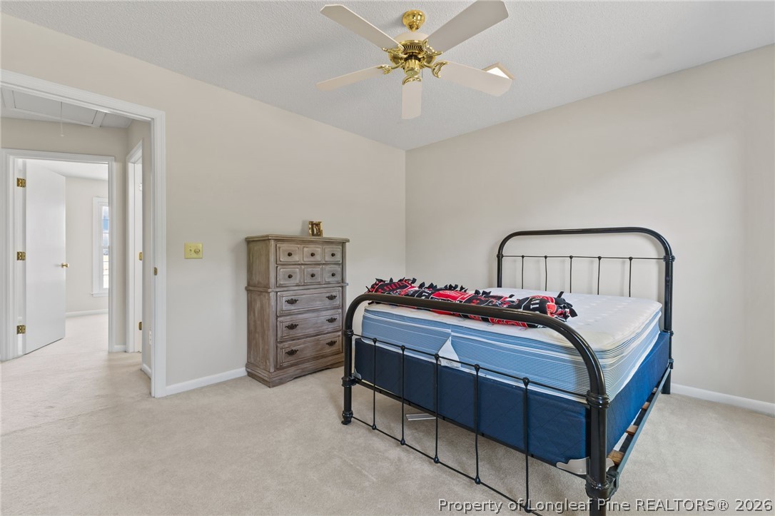 203 White Oak Church Road Clinton, NC 28328 - Photo 17 of 49 a bed room with a bed and a chandelier