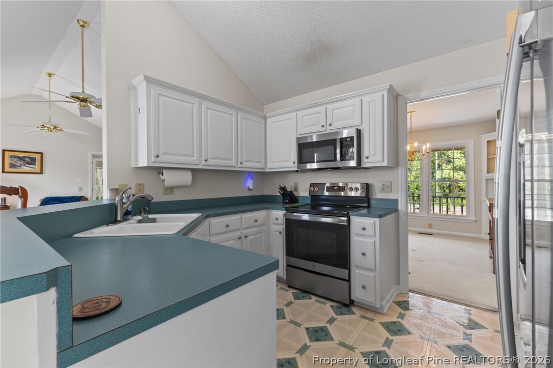 203 White Oak Church Road Clinton, NC 28328 - Photo 20 of 49 a kitchen with stainless steel appliances granite countertop a sink stove and microwave