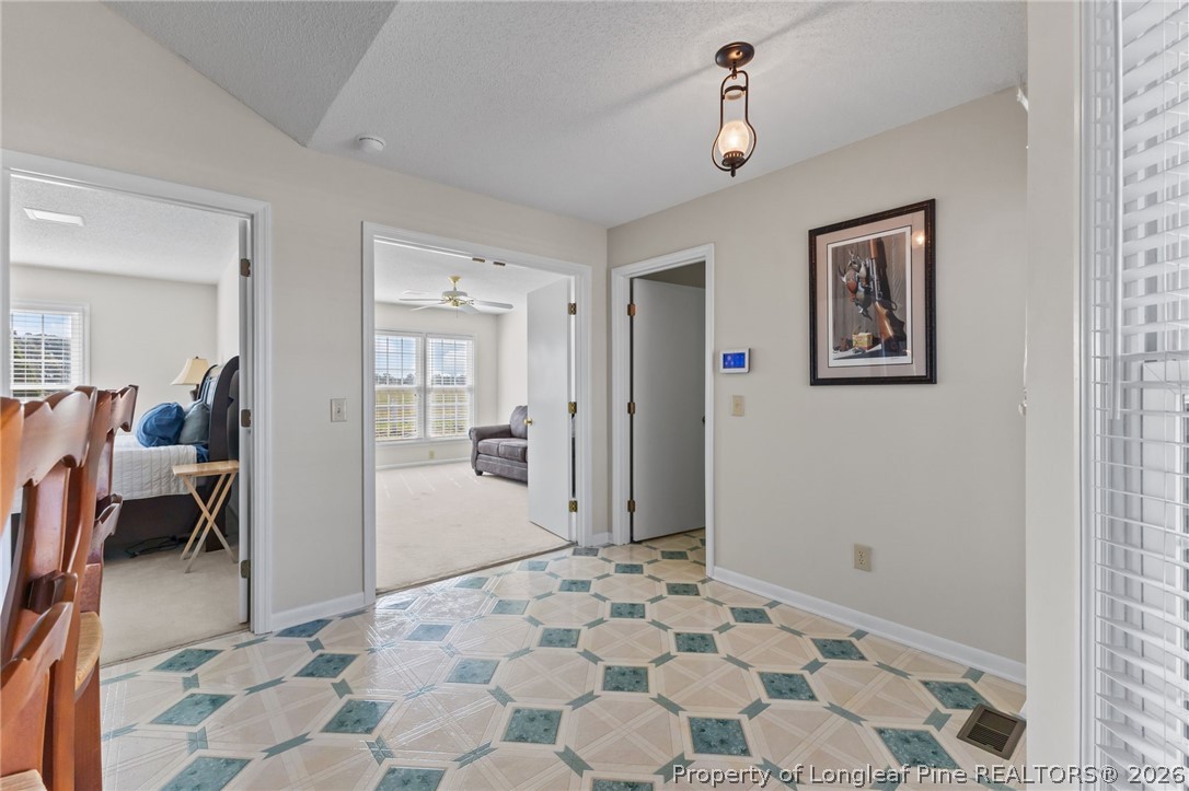 203 White Oak Church Road Clinton, NC 28328 - Photo 22 of 49 a view of a bedroom with wooden floor and furniture