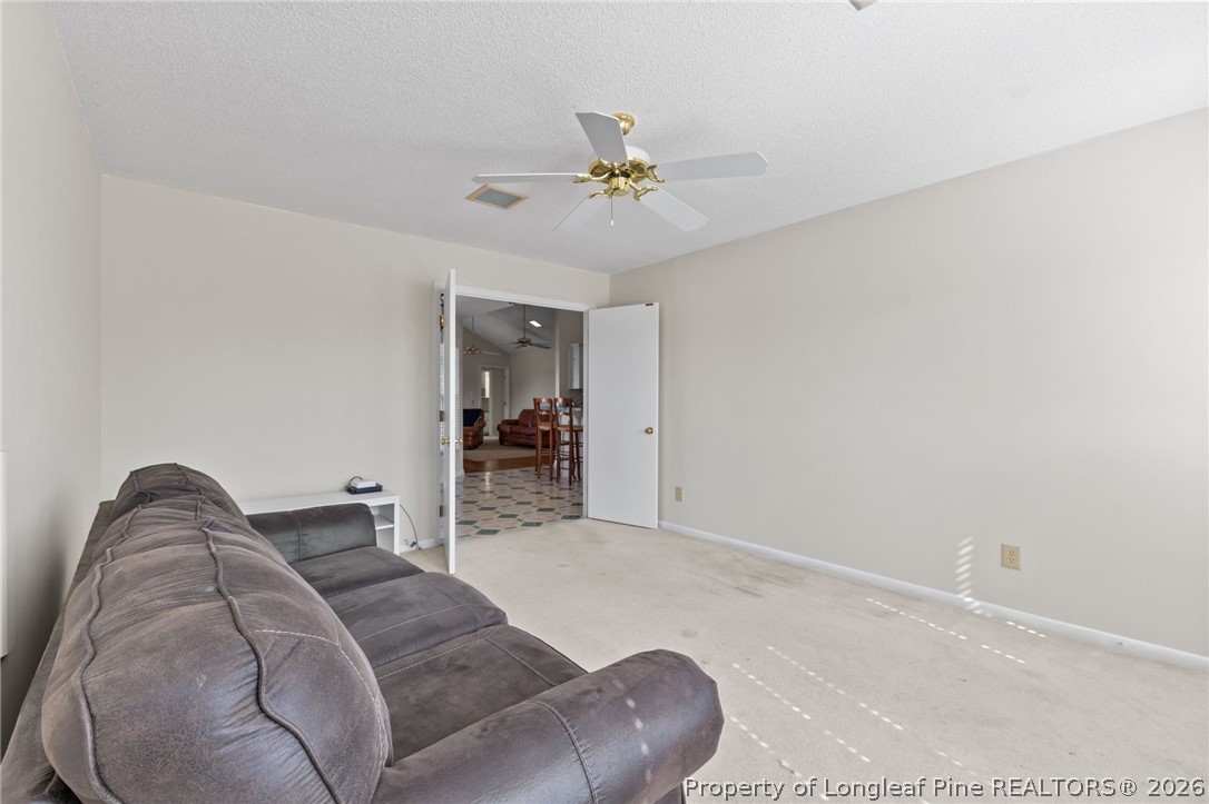 203 White Oak Church Road Clinton, NC 28328 - Photo 25 of 49 a living room with furniture and a chandelier