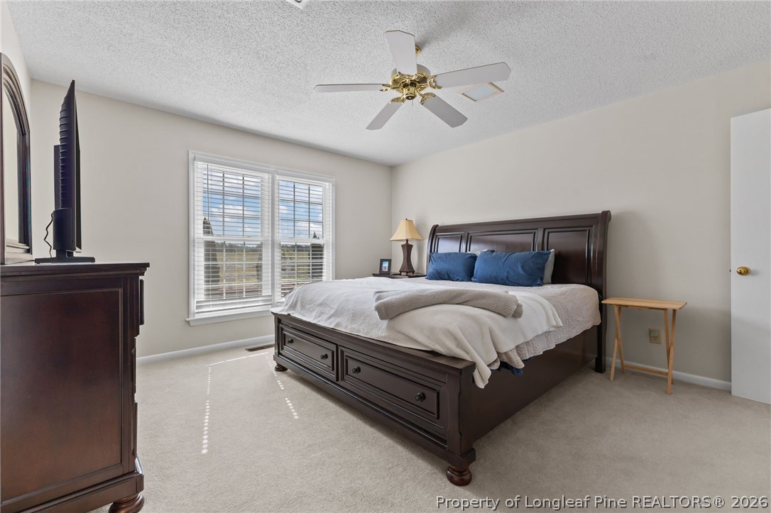 203 White Oak Church Road Clinton, NC 28328 - Photo 26 of 49 a bed sitting in a spacious bedroom next to a window