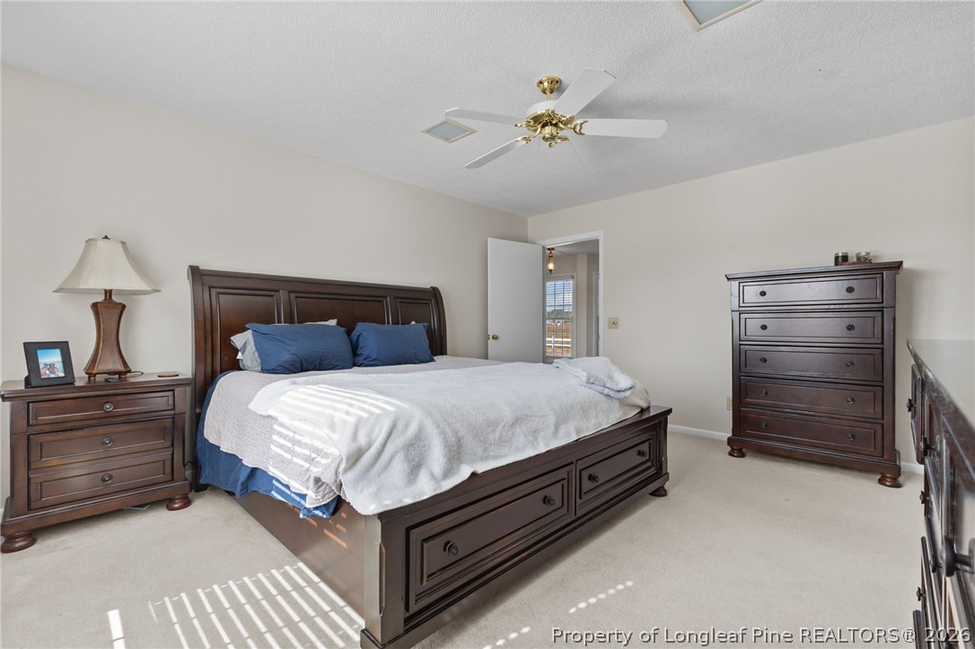 203 White Oak Church Road Clinton, NC 28328 - Photo 27 of 49 a bedroom with a bed and a chandelier