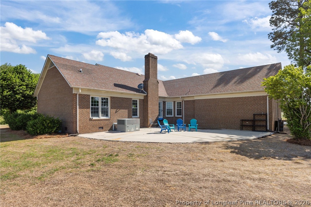 203 White Oak Church Road Clinton, NC 28328 - Photo 6 of 49 a front view of a house with garden and patio
