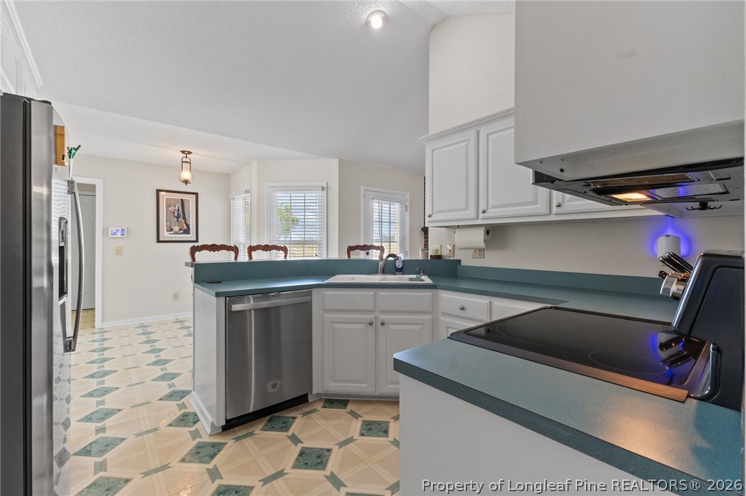 203 White Oak Church Road Clinton, NC 28328 - Photo 8 of 49 a kitchen with a sink cabinets and appliances