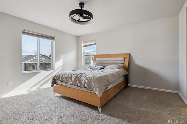 a spacious bedroom with a bed and a large window