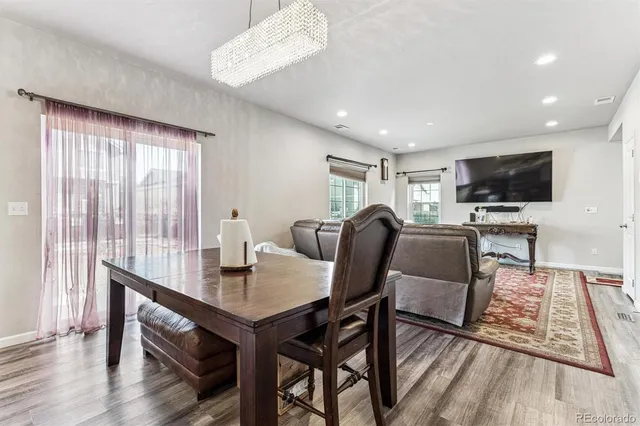 a view of a dining room with furniture window and wooden floor