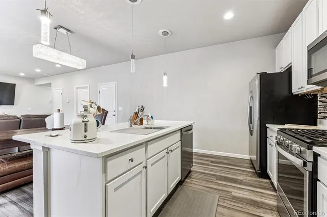 a kitchen with a sink stove and refrigerator
