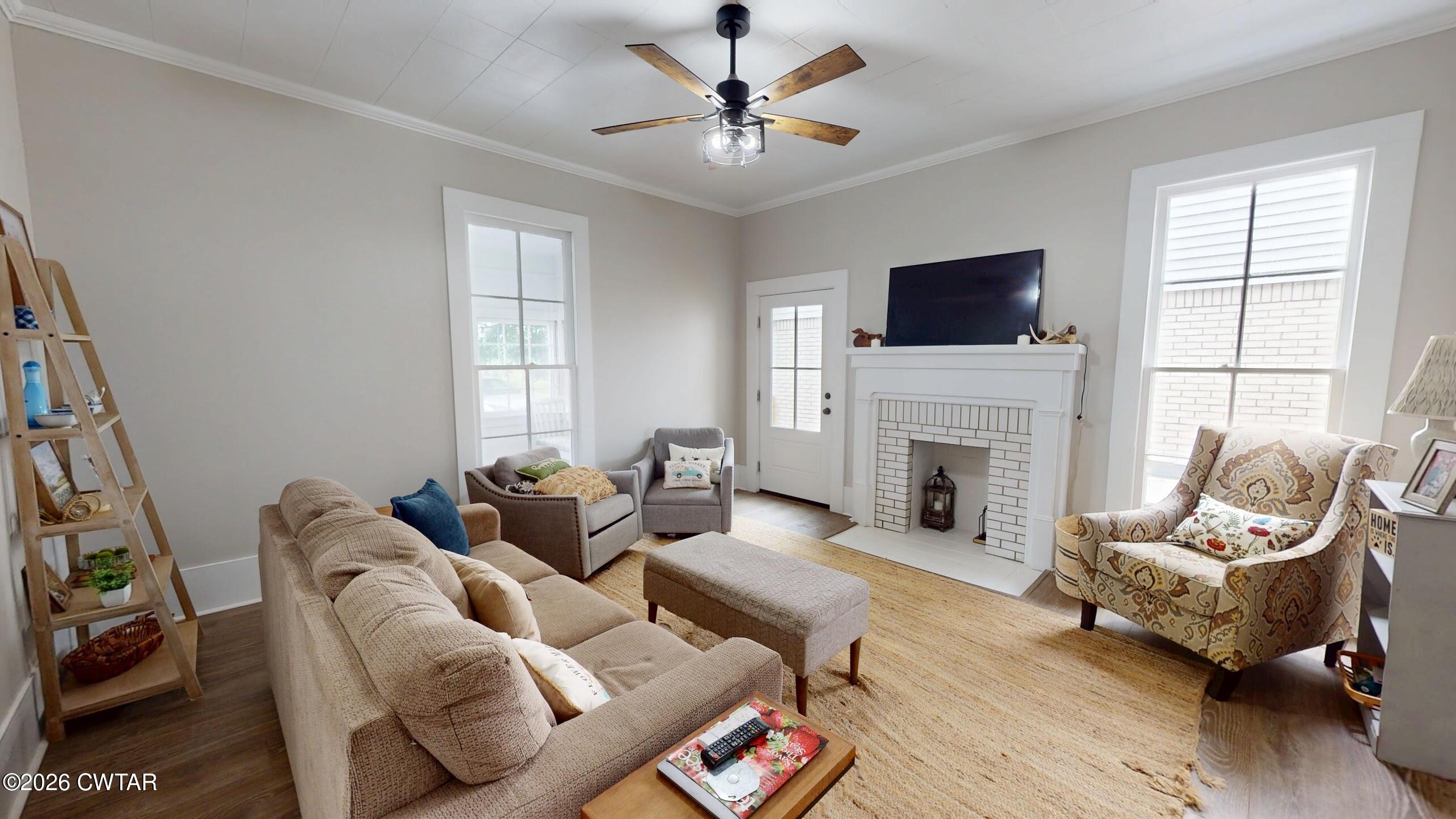 2800 Locust Grove Road Newbern, TN 38059 - Photo 8 of 46 a living room with furniture a fireplace and a flat screen tv