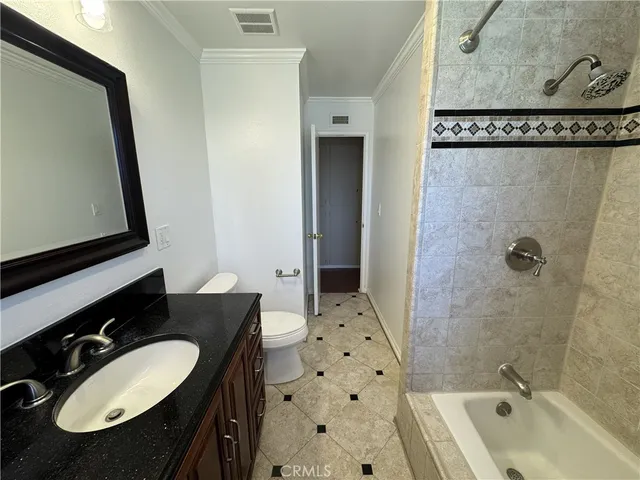 a bathroom with a sink vanity mirror and shower