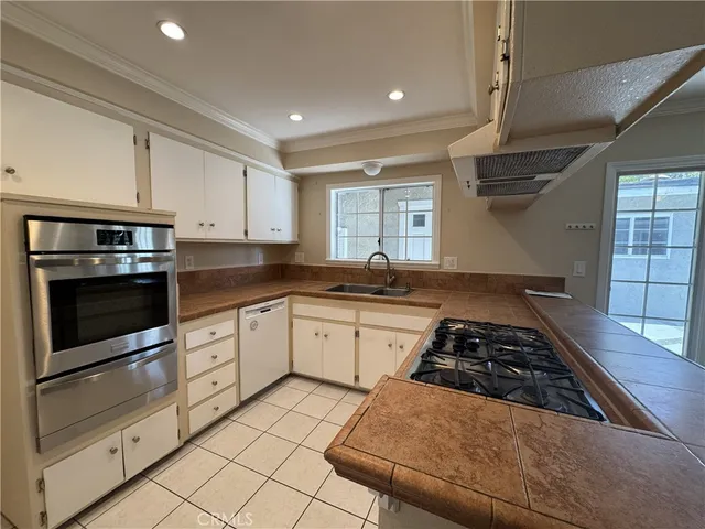 a kitchen with stainless steel appliances granite countertop a stove and a sink