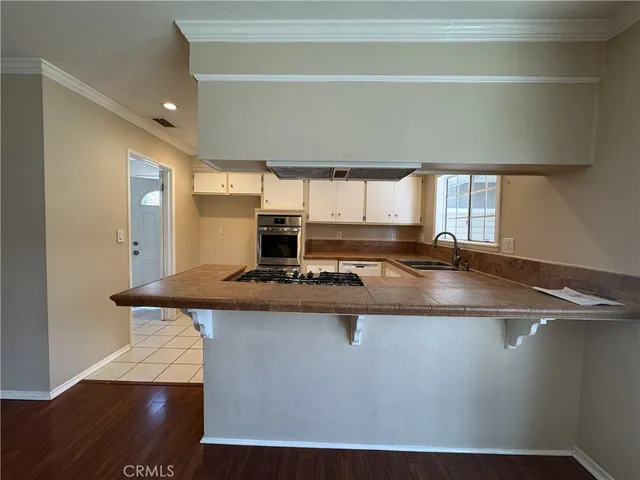 a kitchen with kitchen island a stove a sink and a refrigerator