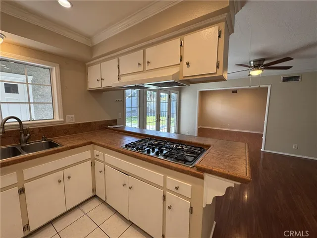 a kitchen with granite countertop a stove sink and cabinets