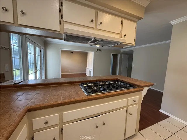 a stove top oven sitting inside of a kitchen