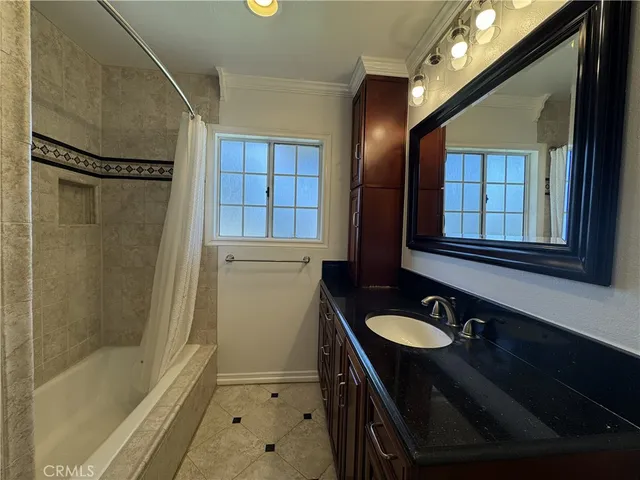 a bathroom with a sink a mirror and a shower