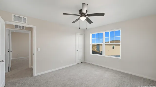 a view of a livingroom with a ceiling fan and wooden floor
