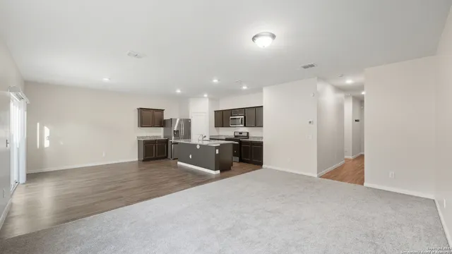 a view of kitchen with kitchen island refrigerator sink and stove