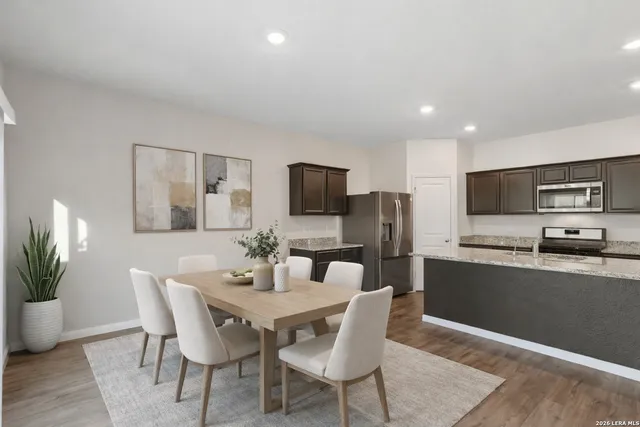 a view of a dining room with furniture and wooden floor