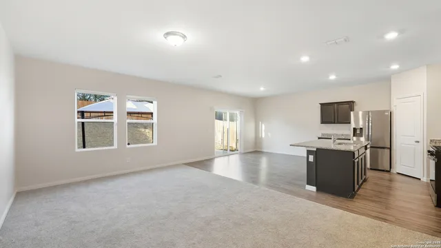 a view of a kitchen with a sink and a stove top oven