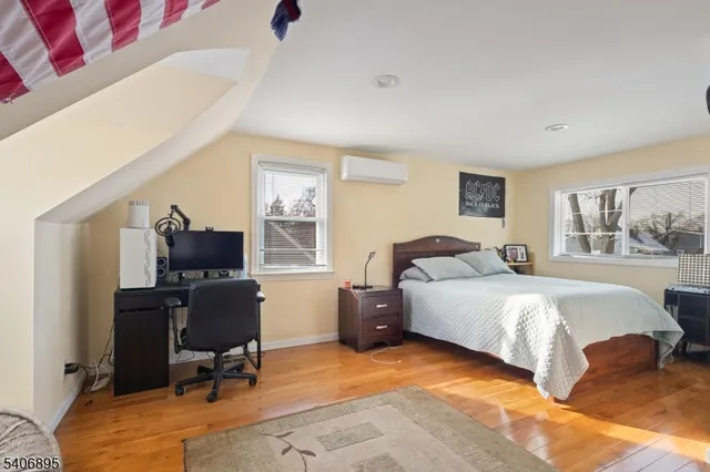 a bedroom with bed chair and window