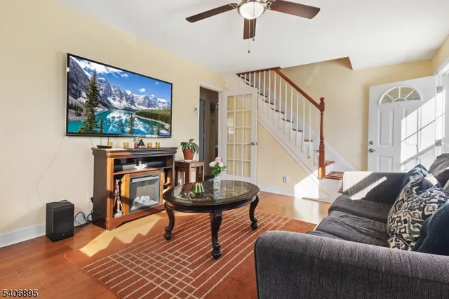 a living room with furniture a rug and a flat screen tv