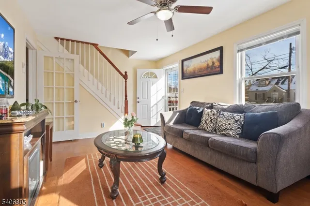 a living room with furniture and a chandelier