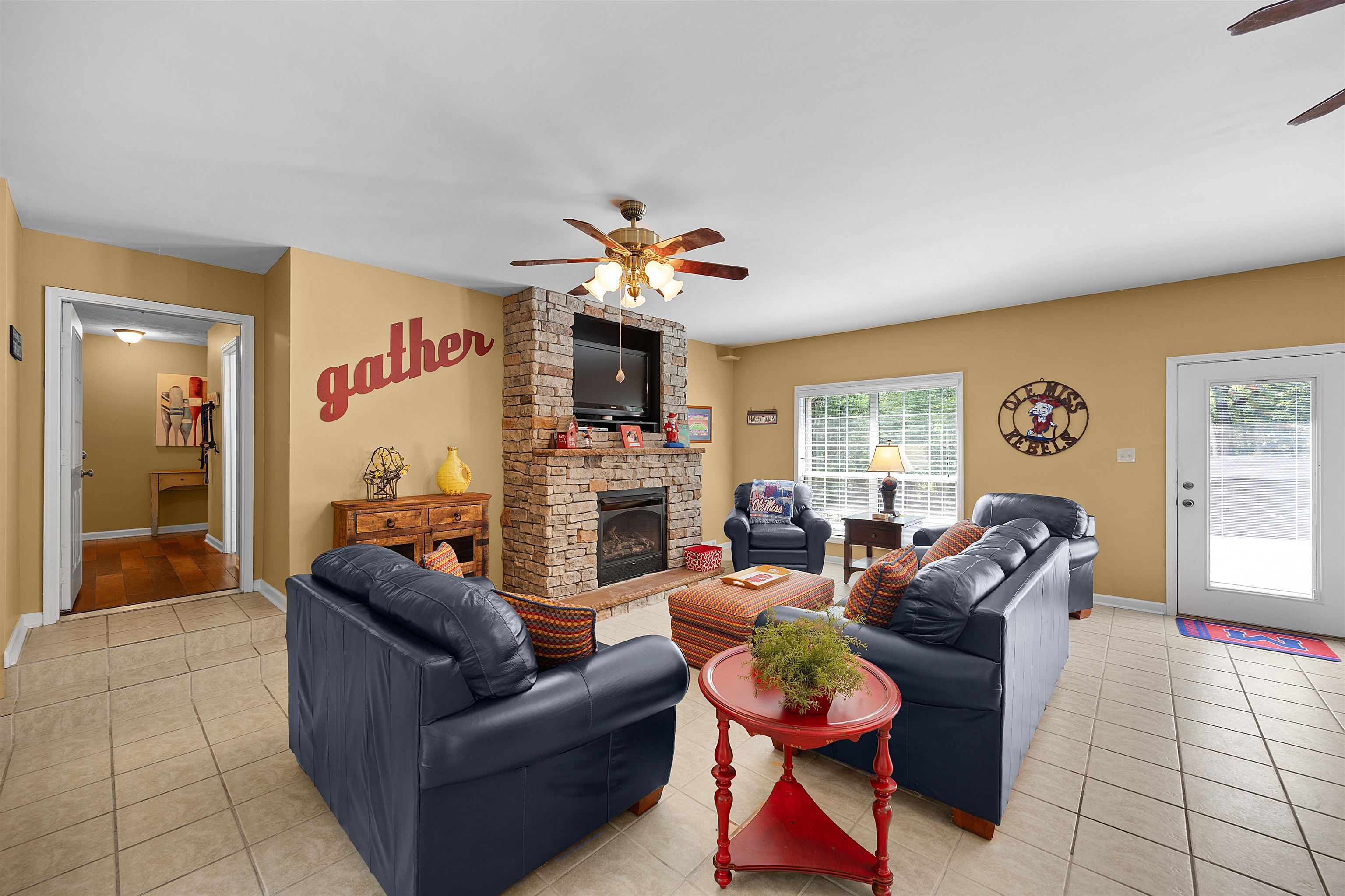 28 County Road 18 Iuka, MS 38852 - Photo 19 of 39 a living room with furniture a fireplace and a flat screen tv