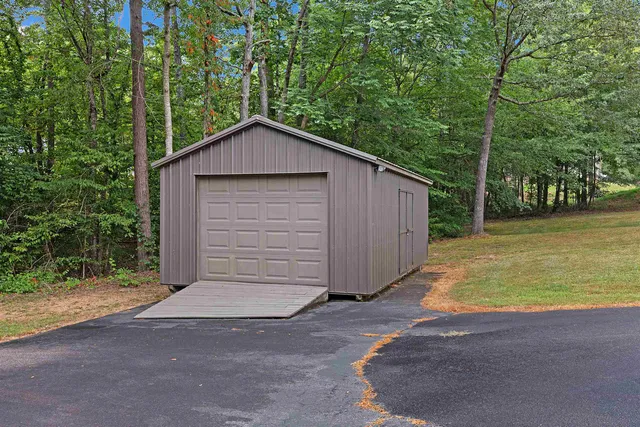 a front view of house with yard and trees